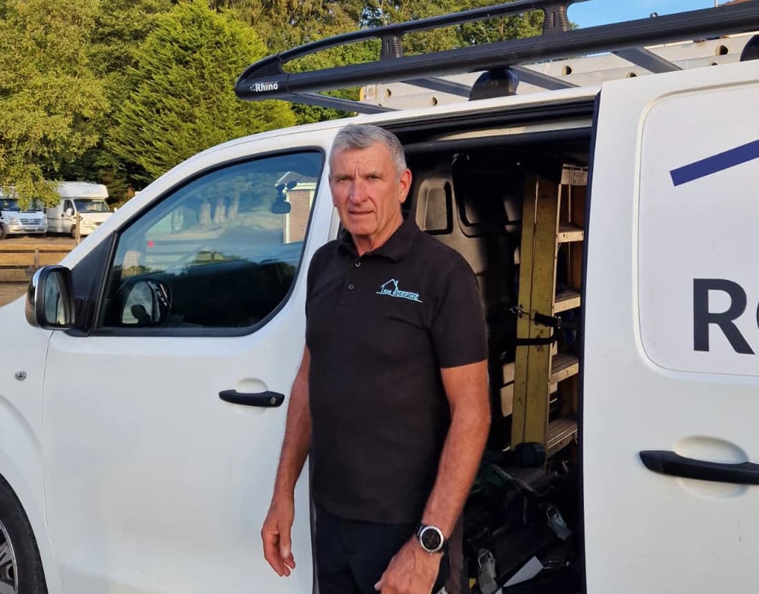 Robert Collins beside an RM Roofing van with ladder racking, South Wales